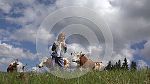 Farmer Child with Cattle on Meadow, Tourist Girl and Cows Animals in Mountains