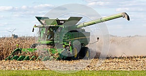 A farmer combining a field of corn