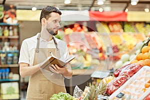 Farmer Counting Produce at Market Stand