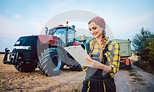Farmer crunching numbers of field after a long harvest day