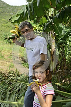 Farmer and daughter in banana plantation