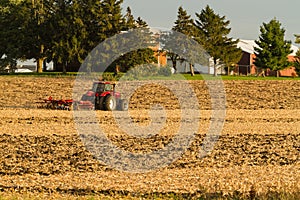 A farmer discing his field on a cool October afternoon.
