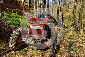 Farmer driving a old tractor