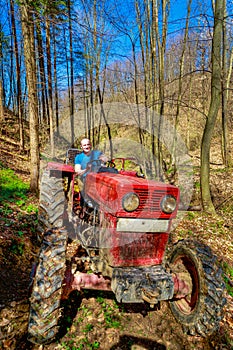 Farmer driving a old tractor