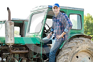 Farmer driving tractor in countryside