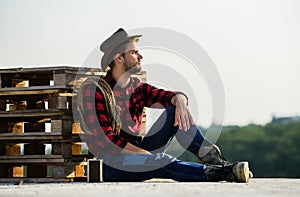 Farmer enjoy view from his farm. Romanticism of western culture. Farmer in hat sit relax. Peaceful mood. Watching sunset