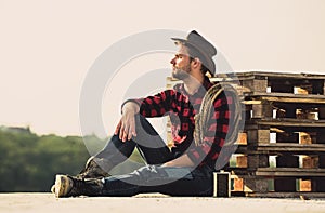 Farmer enjoy view from his farm. Romanticism of western culture. Farmer in hat sit relax. Peaceful mood. Watching sunset photo