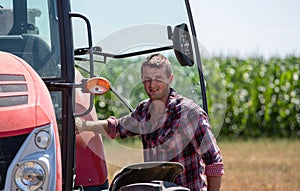 Farmer entering tractor in field