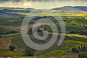 Farmer estate with vineyards at sunrise in San Quirico d'Orcia