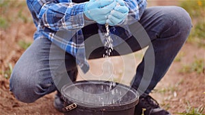 Farmer Examining Herbicides Fertilizer in Hands Before Fertilizing Agriculture Field