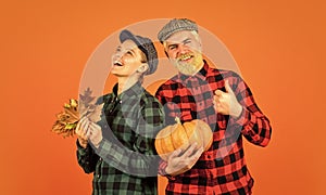 Farmer family concept. Autumn harvesting works. Couple in love checkered rustic outfit. Retro style. Work at fields