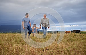 Farmer family walking on a cattle or livestock farm teaching and learning together. Generations of a happy father