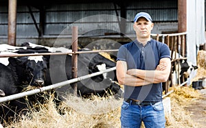 Farmer at farm with dairy cows