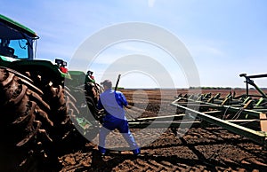 Farmer fixing a tractor