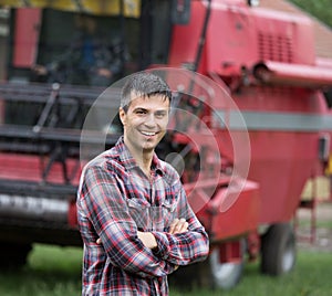 Farmer in front of combine harvester