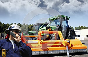 Farmer in front of giant tractor