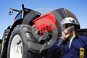 Farmer in front of giant tractor