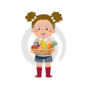 Farmer girl holding basket full of fresh vegetables