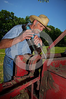 Farmer Greases his Hay Baler