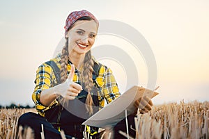 Farmer having harvest finished showing thumps-up