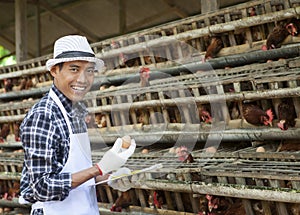 Farmer in hen house