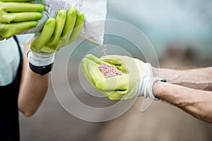 Farmer holding mineral fertilizers