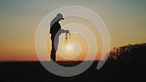 Farmer holding soil in hands on the field