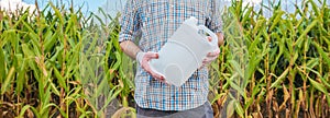 Farmer holding unlabeled pesticide jug in field