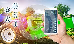 Farmer holds smartphone with infographic on tractor background with potato digger. Farming and smart agriculture. Agricultural