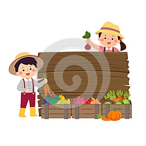 Farmer kids with wooden board and wooden boxes of vegetables