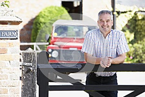 Farmer Looking Over Farm Gate