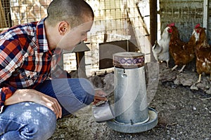 Farmer man feeding the hens