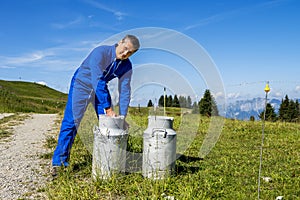 Farmer with milk containers