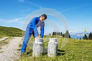 Farmer with milk containers