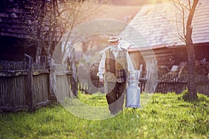 Farmer with milk kettle