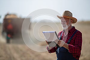Farmer with notebook in field during harvest