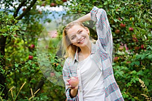 Farmer picking ripe fruit from tree. Harvesting season concept. Woman hold apple garden background. Farm produce organic