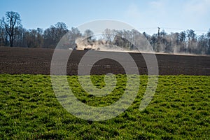 Farmer plowing the field. Cultivating tractor in the field. Red farm tractor with a plow in a farm field. Tractor and Plow