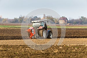 Farmer plowing stubble field