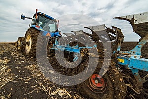 Farmer plowing stubble field