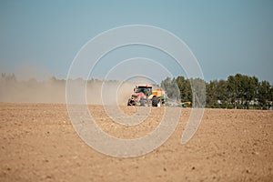 The farmer plows the field with a tractor with a plow