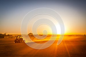 Farmer preparing his field in a tractor ready for spring