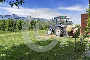 Farmer Preparing Tractor for Orchard Spraying