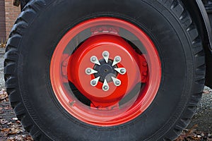 Farmer red tractor wheel large machinery metal rim rubber circle