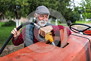 Farmer refilling fuel in tractor on ranch