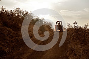 Farmer rides on the tractor