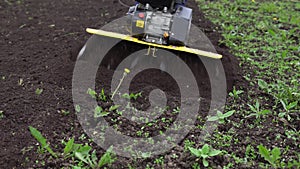 Farmer rips the ground with a cultivator