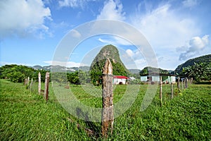 Farmer's fenced home in front of a mogote in Vinales, Pinar del Rio, eastern Cuba