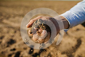 Farmer`s Hands Hold A Handful Of Fertile Land, Close-Up