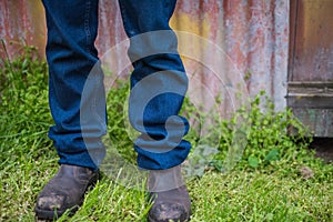 Farmer's legs with boots and jeans photo